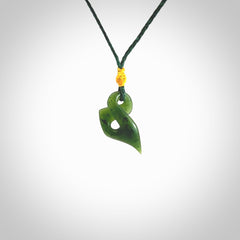 Hand carved small sized, New Zealand jade twist pendant. Carved in New Zealand by NZ Pacific. Hand made small Jade twist with adjustable green cord by Shaun Gardiner.