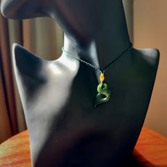 Hand carved small sized, New Zealand jade twist pendant. Carved in New Zealand by NZ Pacific. Hand made small Jade twist with adjustable green cord by Shaun Gardiner.