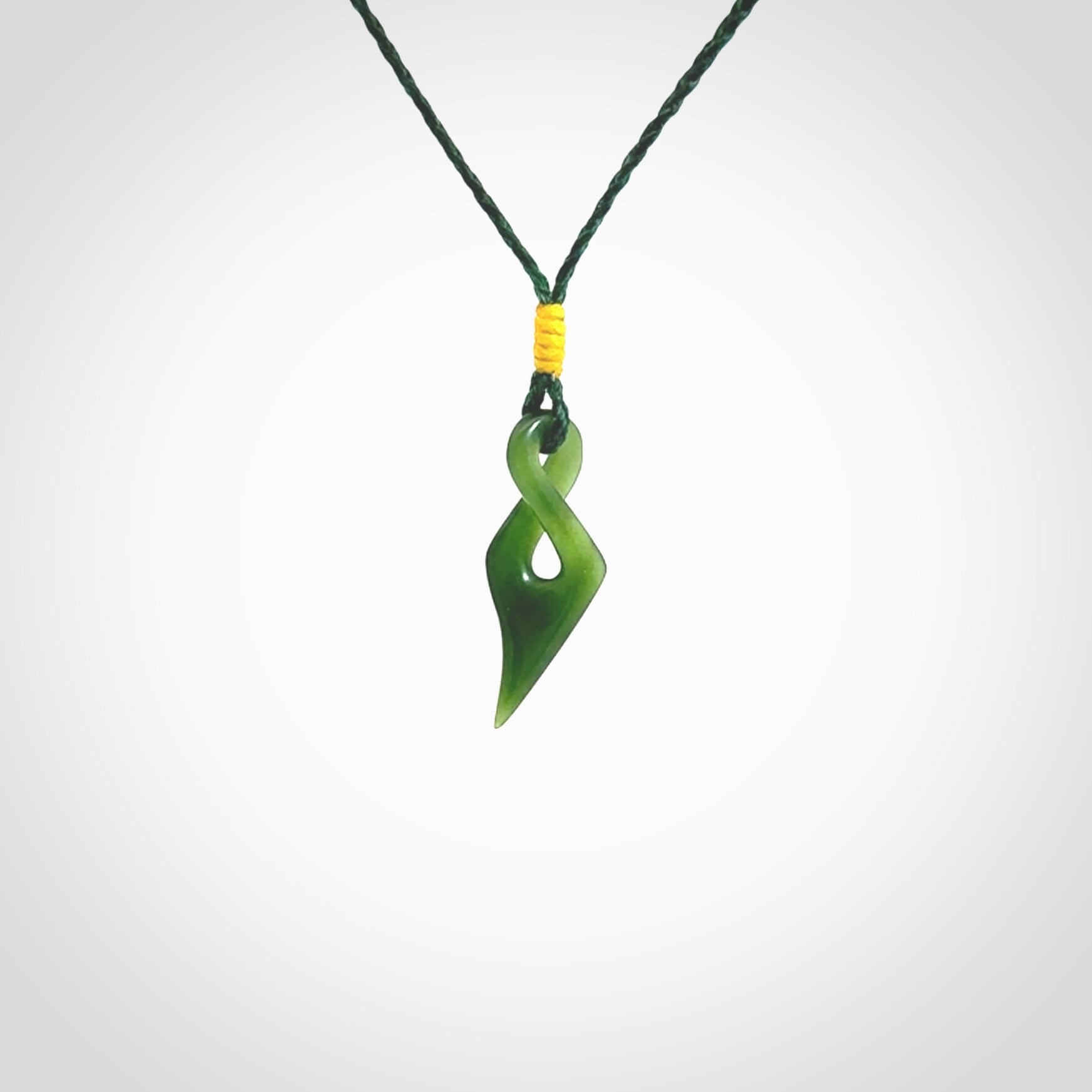 Hand carved small sized, New Zealand jade twist pendant. Carved in New Zealand by NZ Pacific. Hand made small Jade twist with adjustable green cord by Shaun Gardiner.