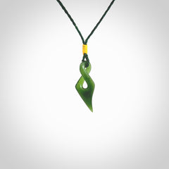 Hand carved small sized, New Zealand jade twist pendant. Carved in New Zealand by NZ Pacific. Hand made small Jade twist with adjustable green cord by Shaun Gardiner.