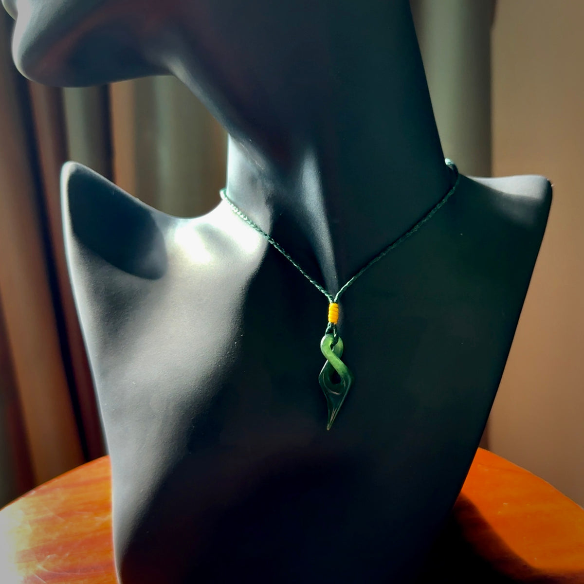 Hand carved small sized, New Zealand jade twist pendant. Carved in New Zealand by NZ Pacific. Hand made small Jade twist with adjustable green cord by Shaun Gardiner.