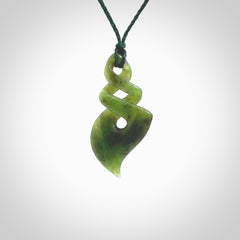 This is a striking, medium sized double twist pendant carved in New Zealand jade by Shaun Gardiner. Hand made Jade twist with adjustable green cord.