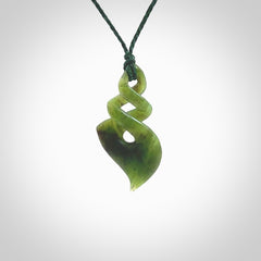 This is a striking, medium sized double twist pendant carved in New Zealand jade by Shaun Gardiner. Hand made Jade twist with adjustable green cord.