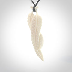 A hand carved large bone double fern leaf necklace. A beautiful large double fern leaf pendant carved from bone for NZ Pacific. This is a true piece of wearable art and is provided with an adjustable black cord.