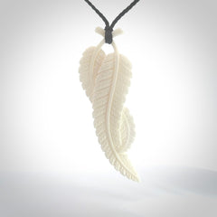 A hand carved large bone double fern leaf necklace. A beautiful large double fern leaf pendant carved from bone for NZ Pacific. This is a true piece of wearable art and is provided with an adjustable black cord.