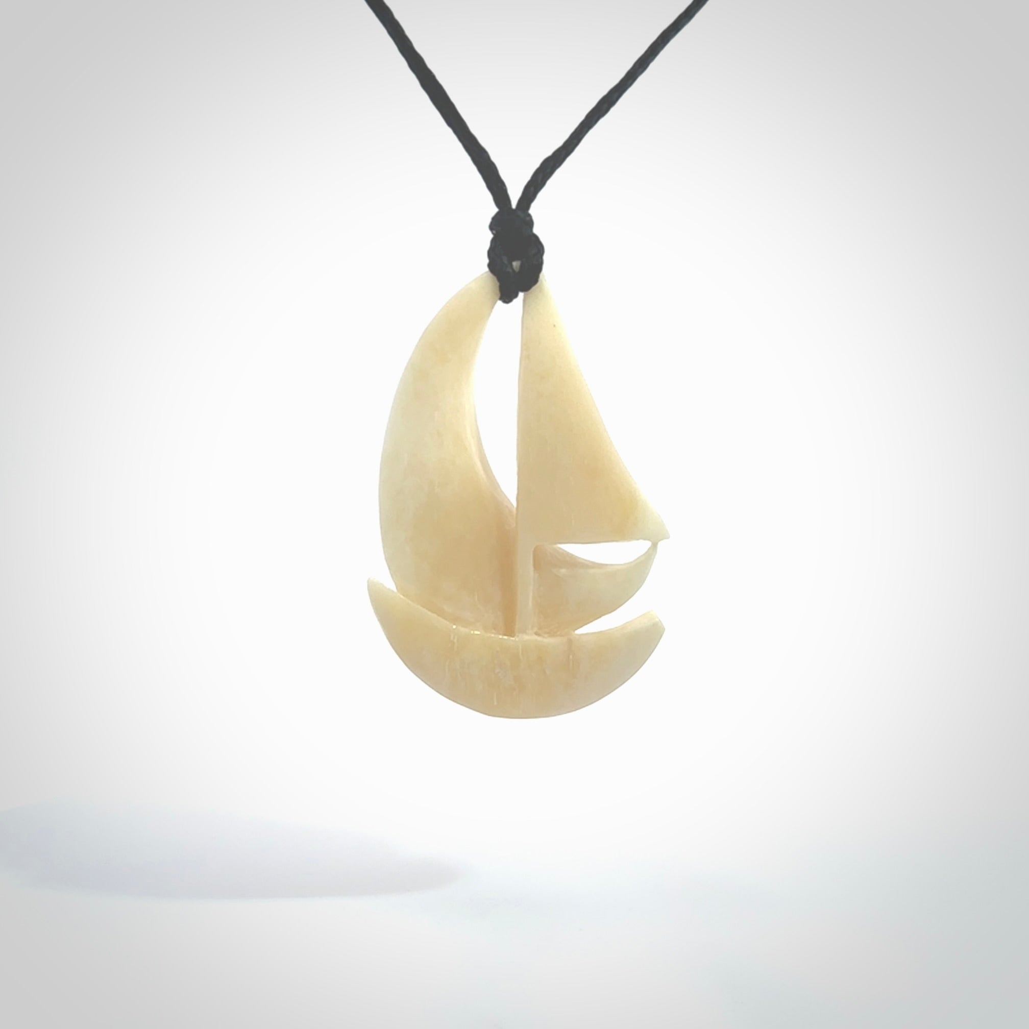 Hand carved sailboat pendant. Carved in natural bone. Moana pendants for sale online.