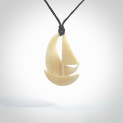 Hand carved sailboat pendant. Carved in natural bone. Moana pendants for sale online.