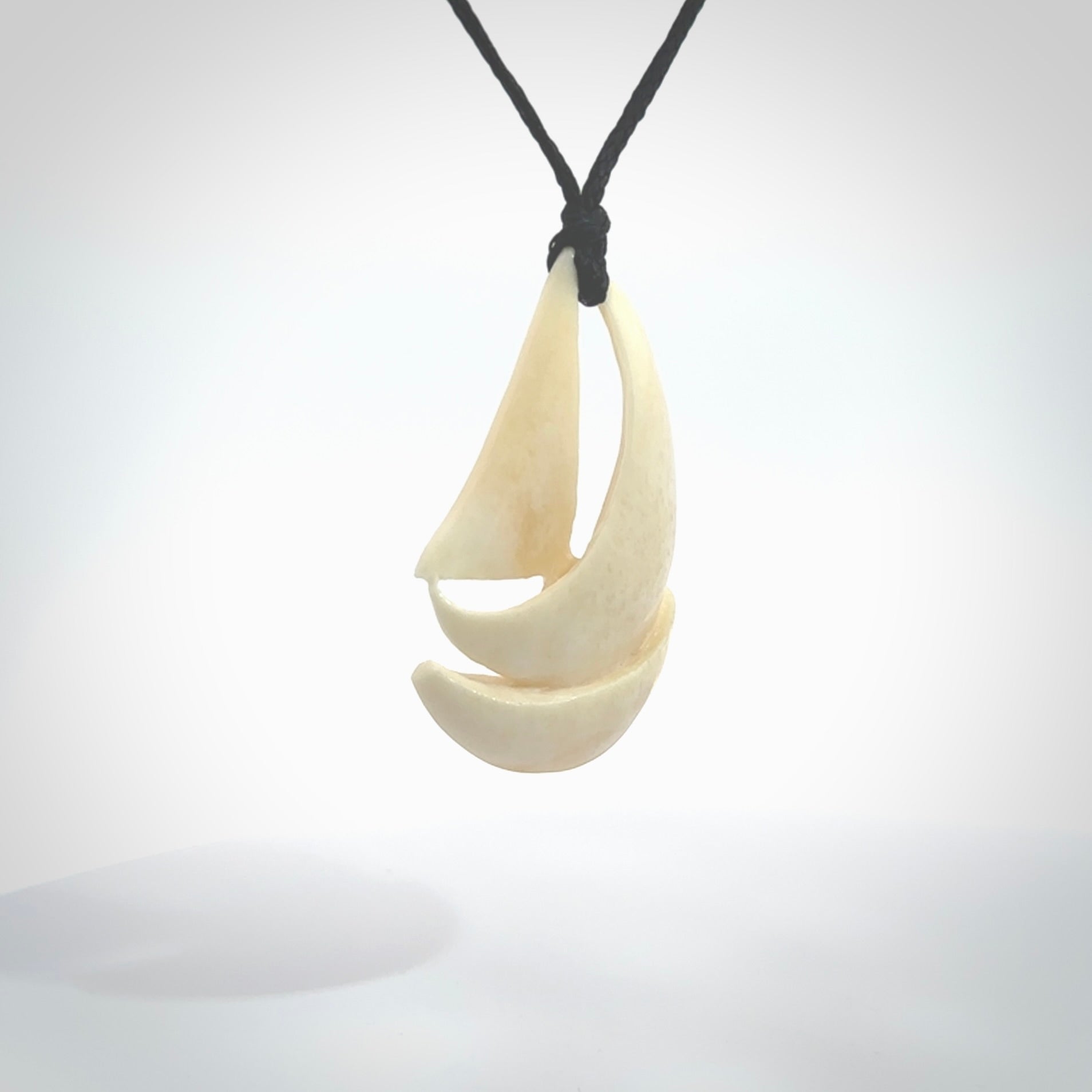 Hand carved sailboat pendant. Carved in natural bone. Moana pendants for sale online.