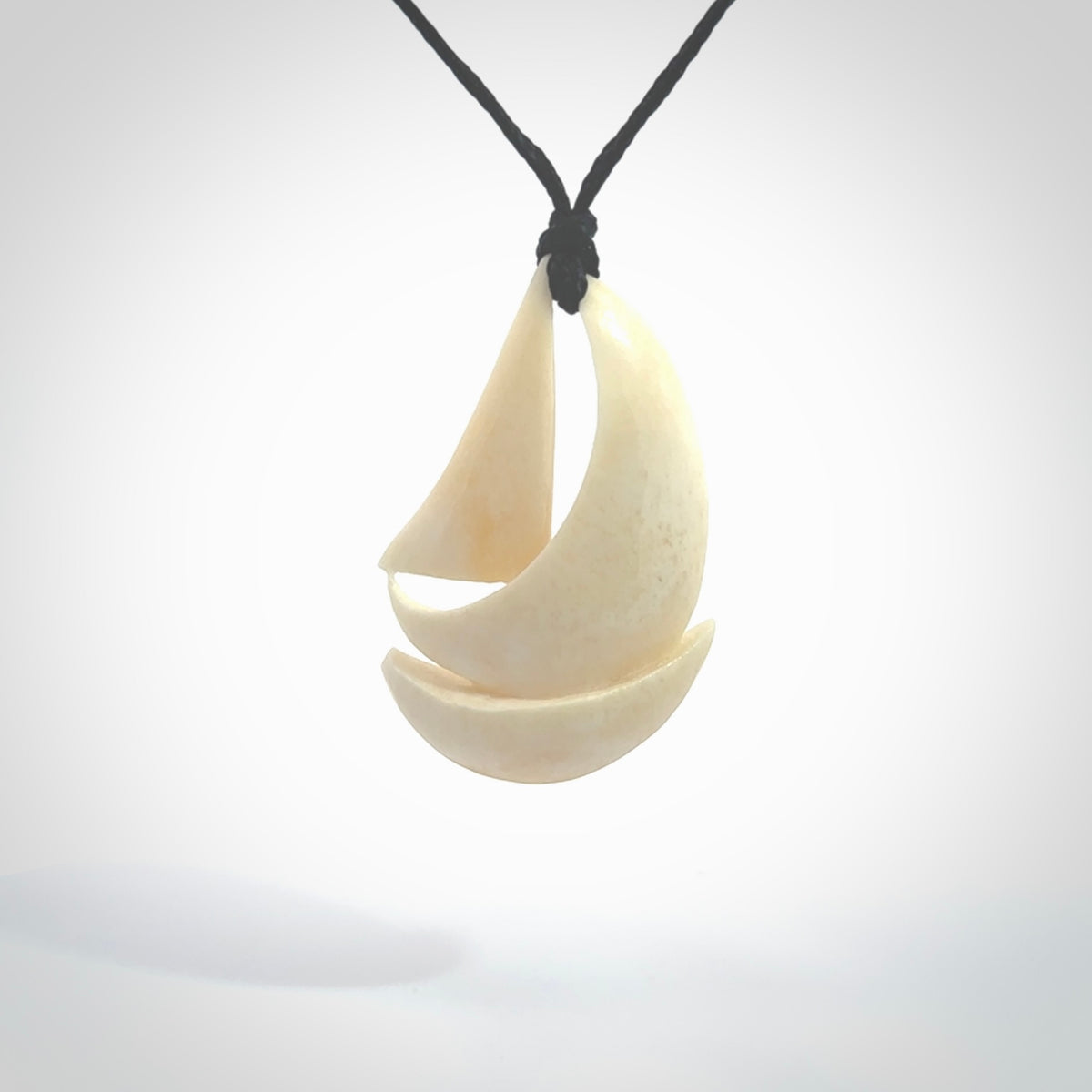 Hand carved sailboat pendant. Carved in natural bone. Moana pendants for sale online.