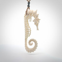 A hand carved intricate and complex seahorse skeleton pendant from bone. The cord is tan and adjustable in length. Large hand made seahorse skeleton necklace. One only.