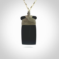 Hand carved black jade toki pendant. Made by NZ Pacific from Australian black jade. Black Jade Toki provided with adjustable cords and packaged in a woven kete pouch. Delivered with express courier.