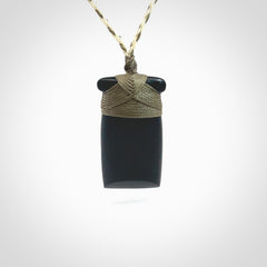 Hand carved black jade toki pendant. Made by NZ Pacific from Australian black jade. Black Jade Toki provided with adjustable cords and packaged in a woven kete pouch. Delivered with express courier.