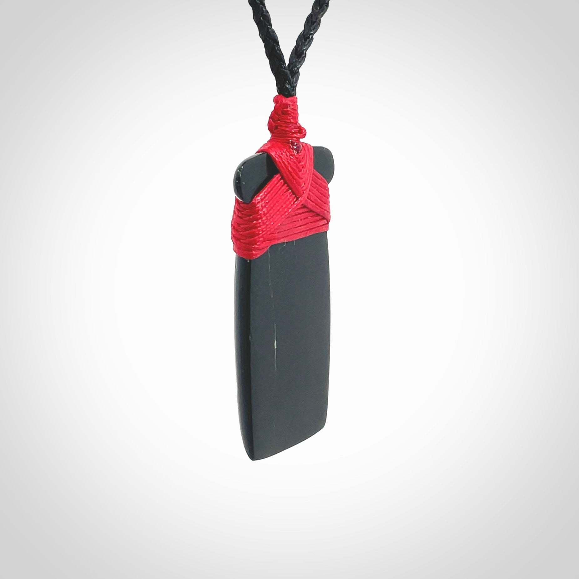 Hand carved black jade toki pendant. Made by NZ Pacific from Australian black jade. Black Jade Toki provided with adjustable cords and packaged in a woven kete pouch. Delivered with express courier.