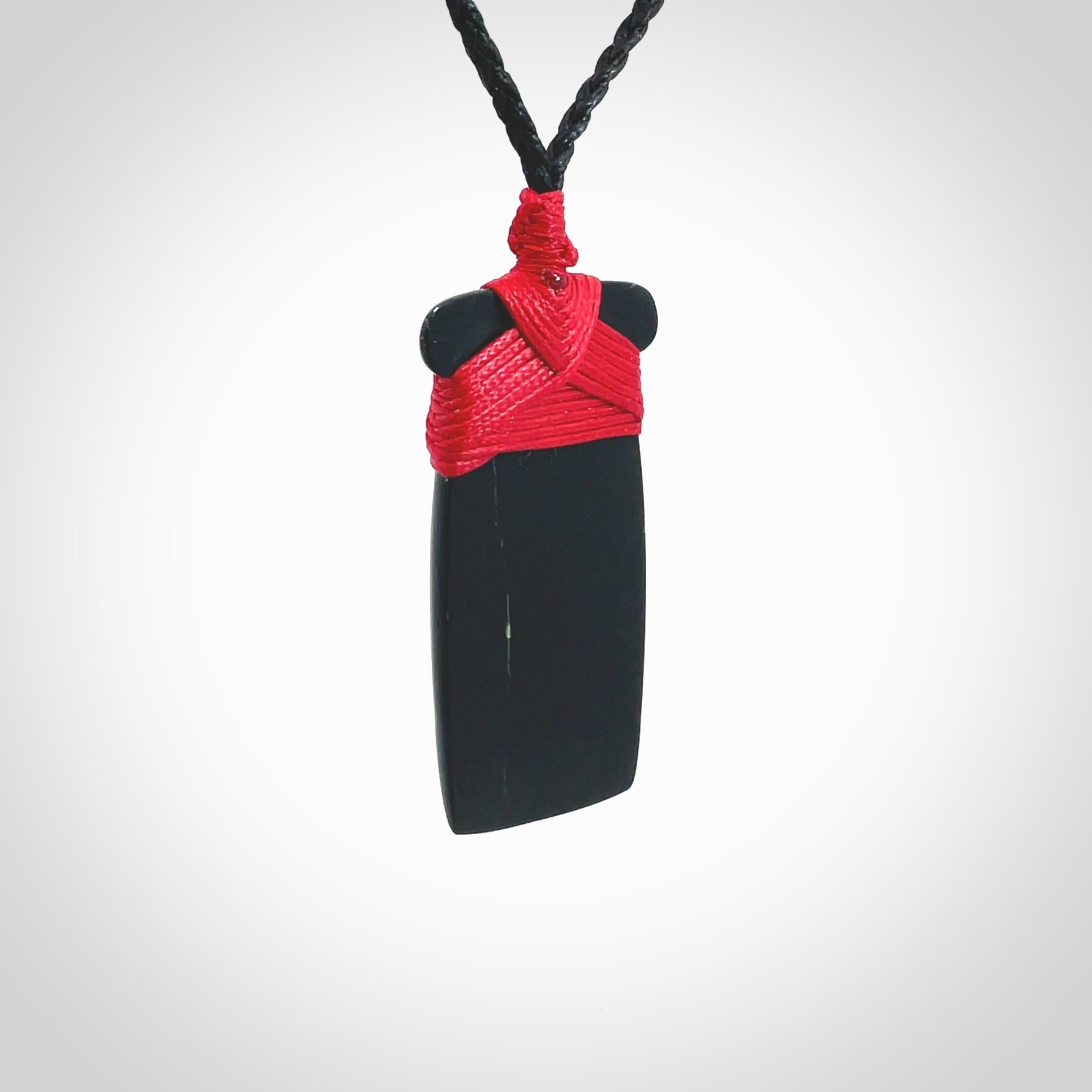 Hand carved black jade toki pendant. Made by NZ Pacific from Australian black jade. Black Jade Toki provided with adjustable cords and packaged in a woven kete pouch. Delivered with express courier.