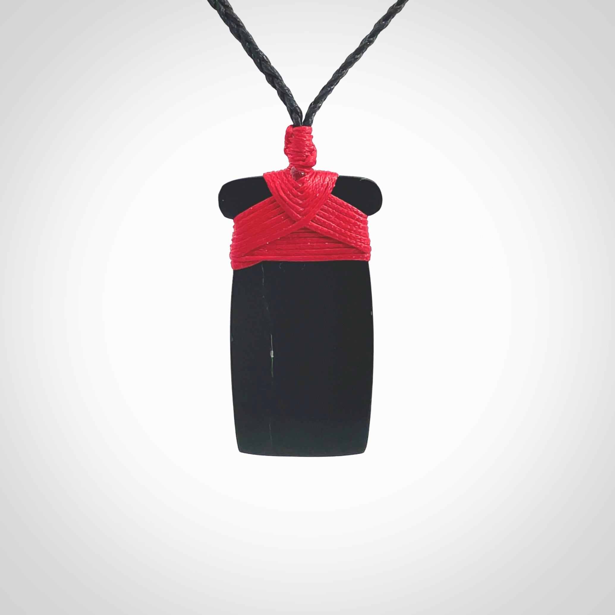 Hand carved black jade toki pendant. Made by NZ Pacific from Australian black jade. Black Jade Toki provided with adjustable cords and packaged in a woven kete pouch. Delivered with express courier.