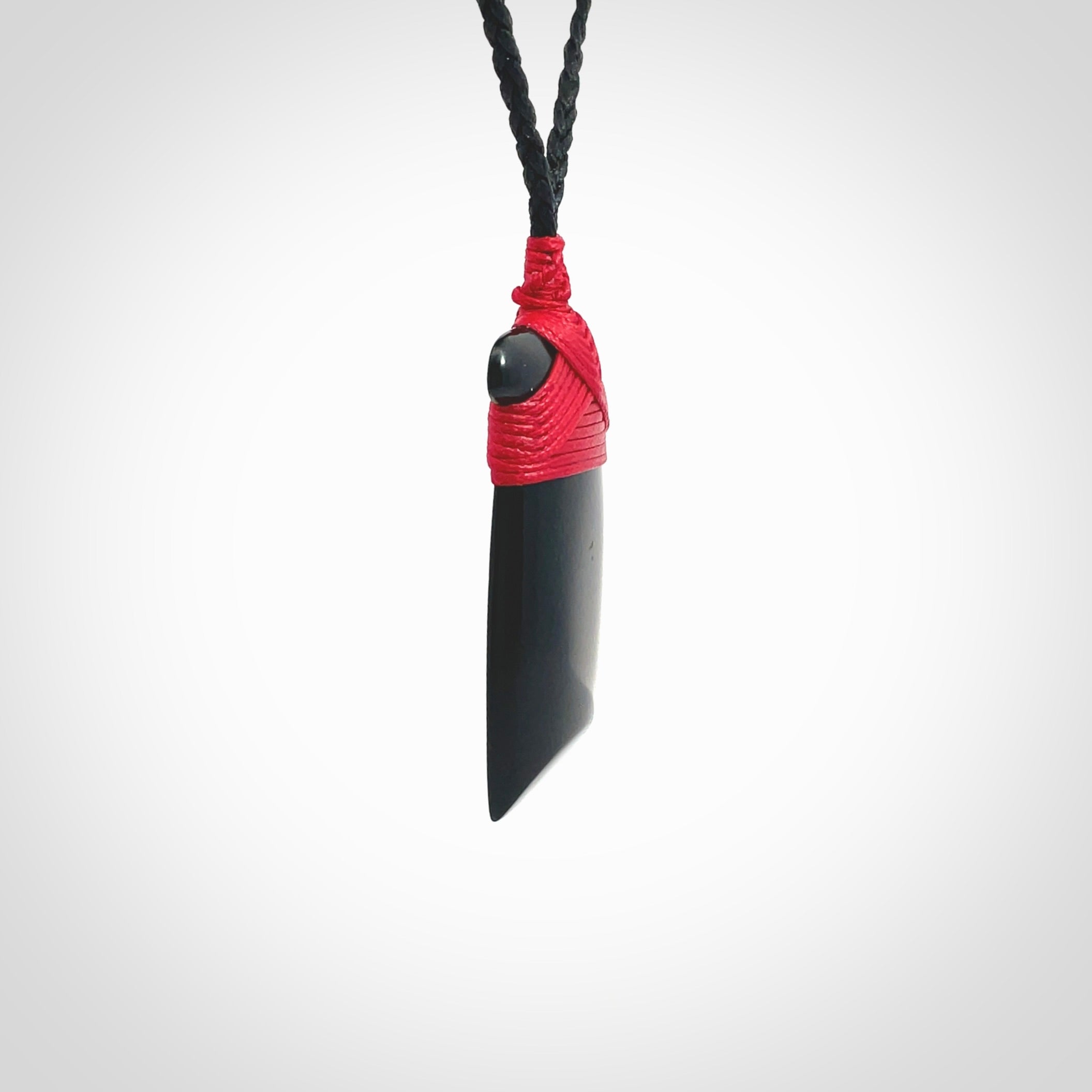 Hand carved black jade toki pendant. Made by NZ Pacific from Australian black jade. Black Jade Toki provided with adjustable cords and packaged in a woven kete pouch. Delivered with express courier.