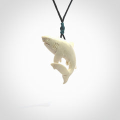 Hand carved shark pendant. Natural bone pendants from NZ Pacific. Provided with adjustable black cord and packaged in a woven kete pouch.