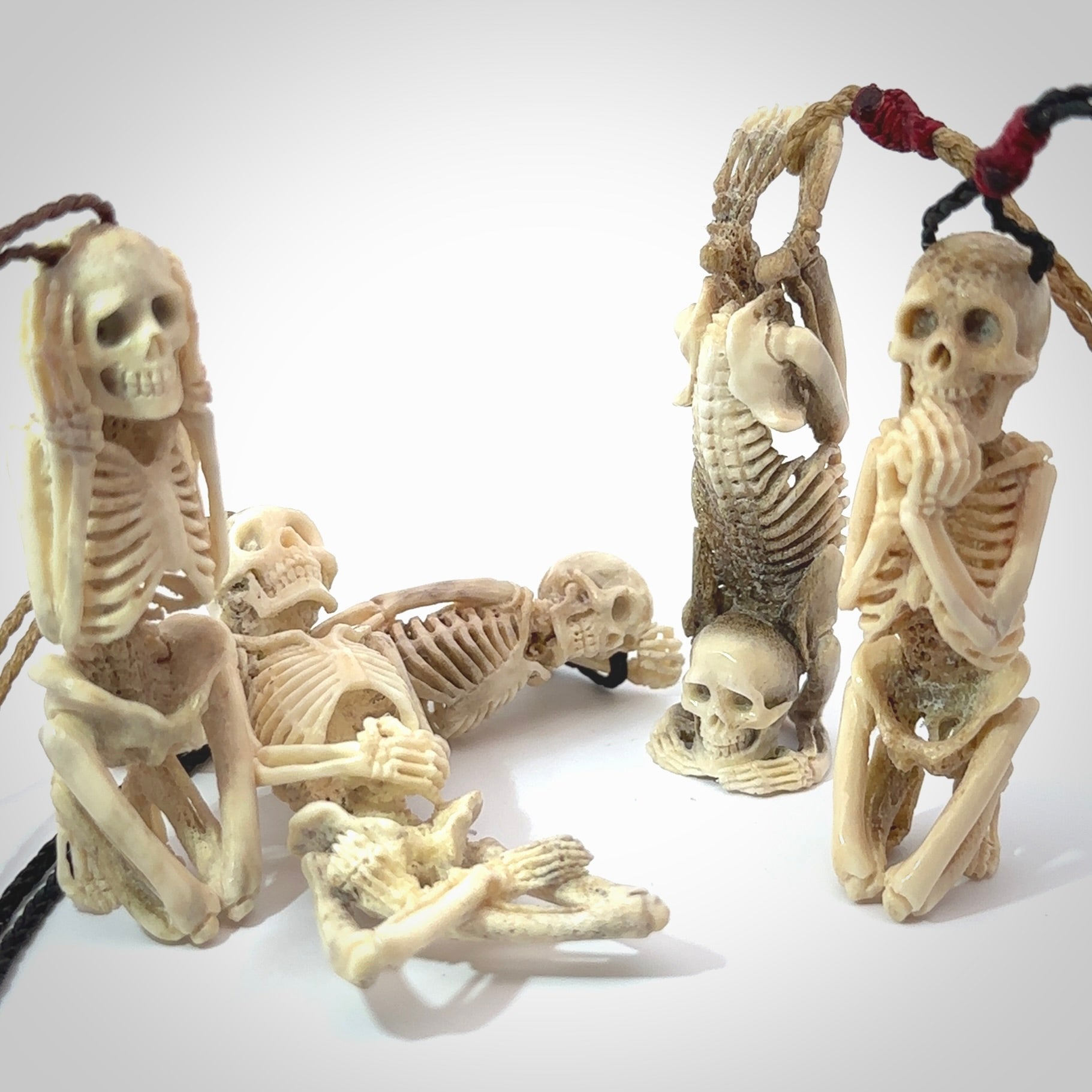 Hand carved Deer Antlr Skeleton figurine necklaces with adjustable cords.