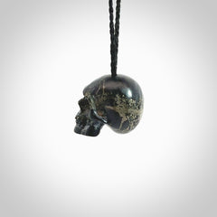 This picture shows a medium sized Snowflake Obsidian stone skull pendant that we have hand carved. It is polished to a soft shine and is a very striking piece. Provided with an adjustable black cord.