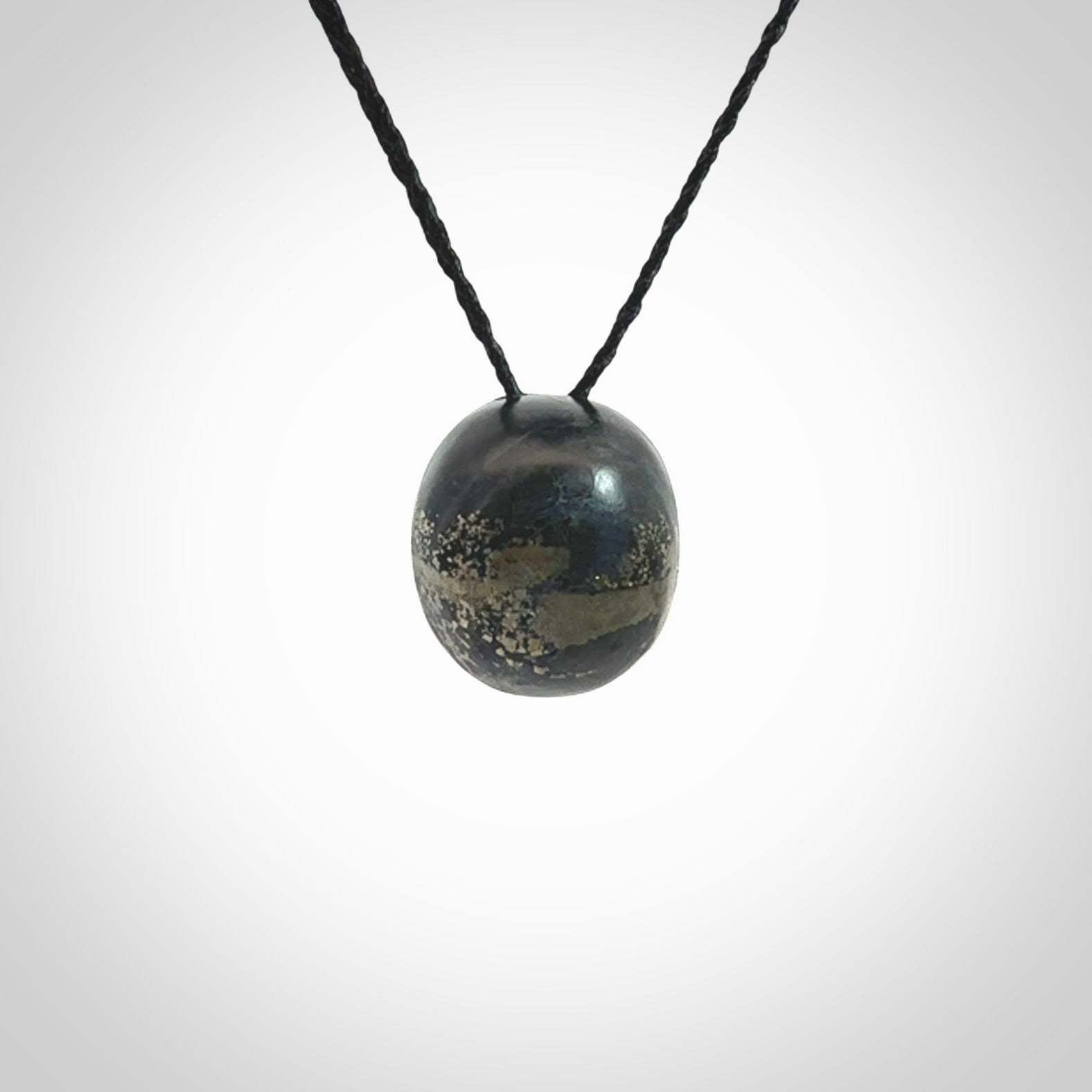 This picture shows a medium sized Snowflake Obsidian stone skull pendant that we have hand carved. It is polished to a soft shine and is a very striking piece. Provided with an adjustable black cord.