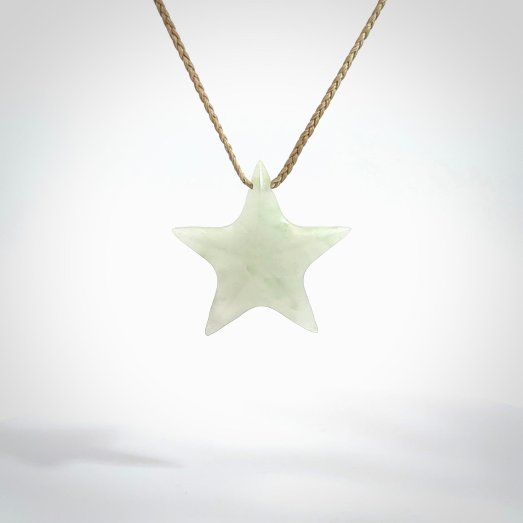 Small Jadeite star pendant. Star shaped necklace hand made from white Jadeite stone. Delivered on an adjustable oat coloured cord and packaged in a woven kete pouch.