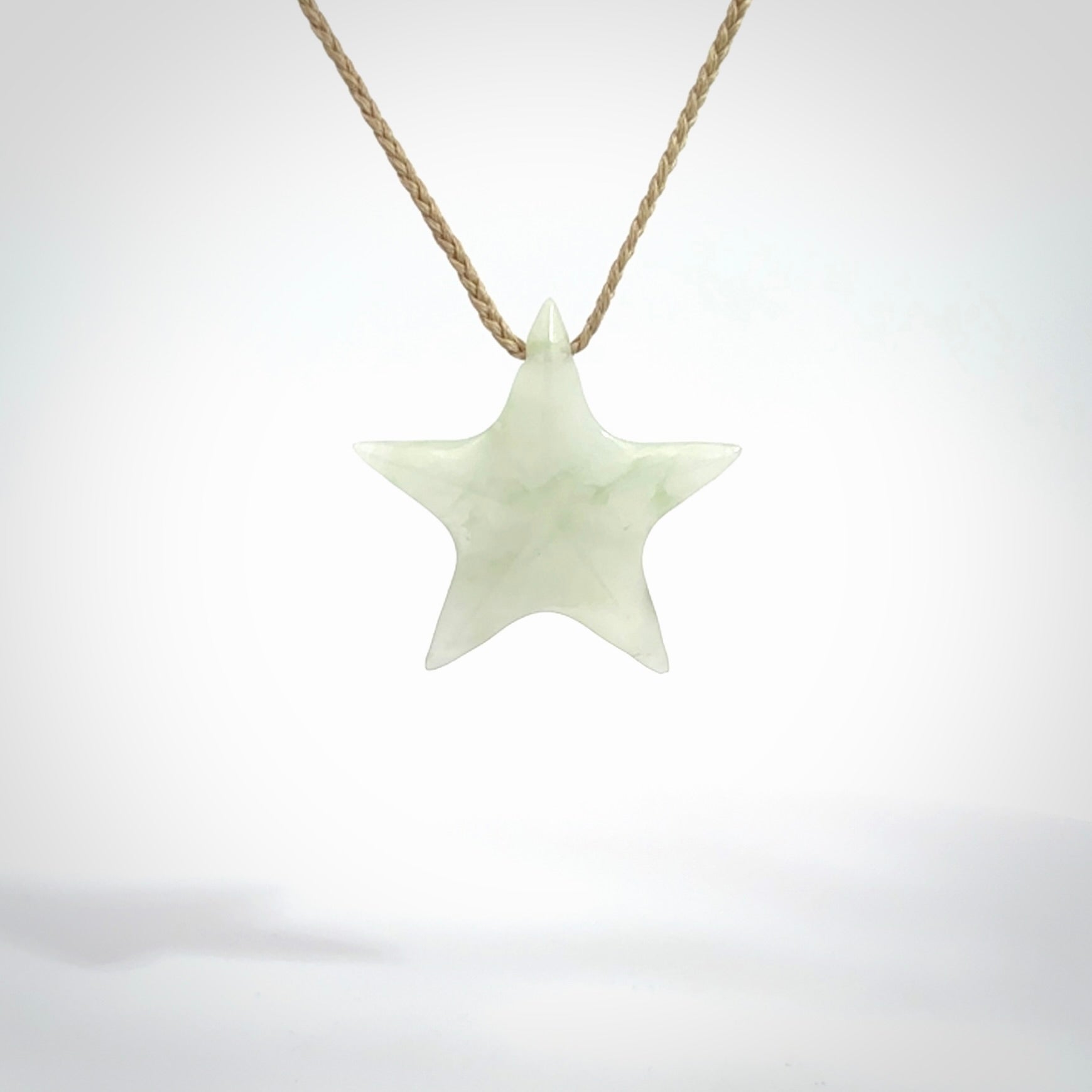 Small Jadeite star pendant. Star shaped necklace hand made from white Jadeite stone. Delivered on an adjustable oat coloured cord and packaged in a woven kete pouch.