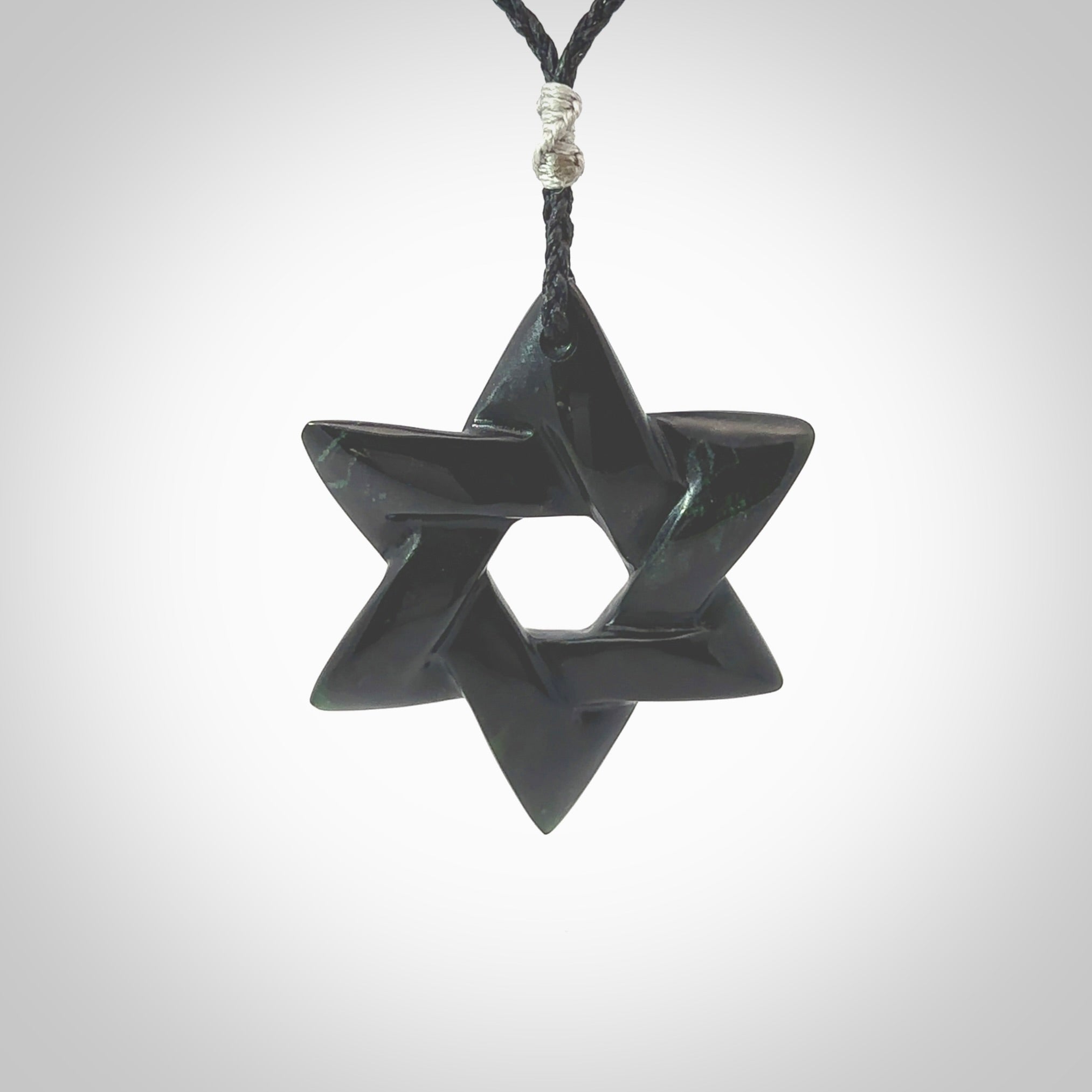 Hand carved New Zealand Tangiwai Pounamu Magen David necklace. Unique and creative art to wear from New Zealand Tangiwai Pounamu. Hand made New Zealand Tangiwai star of david pendant. Magen David pendant for men and women.