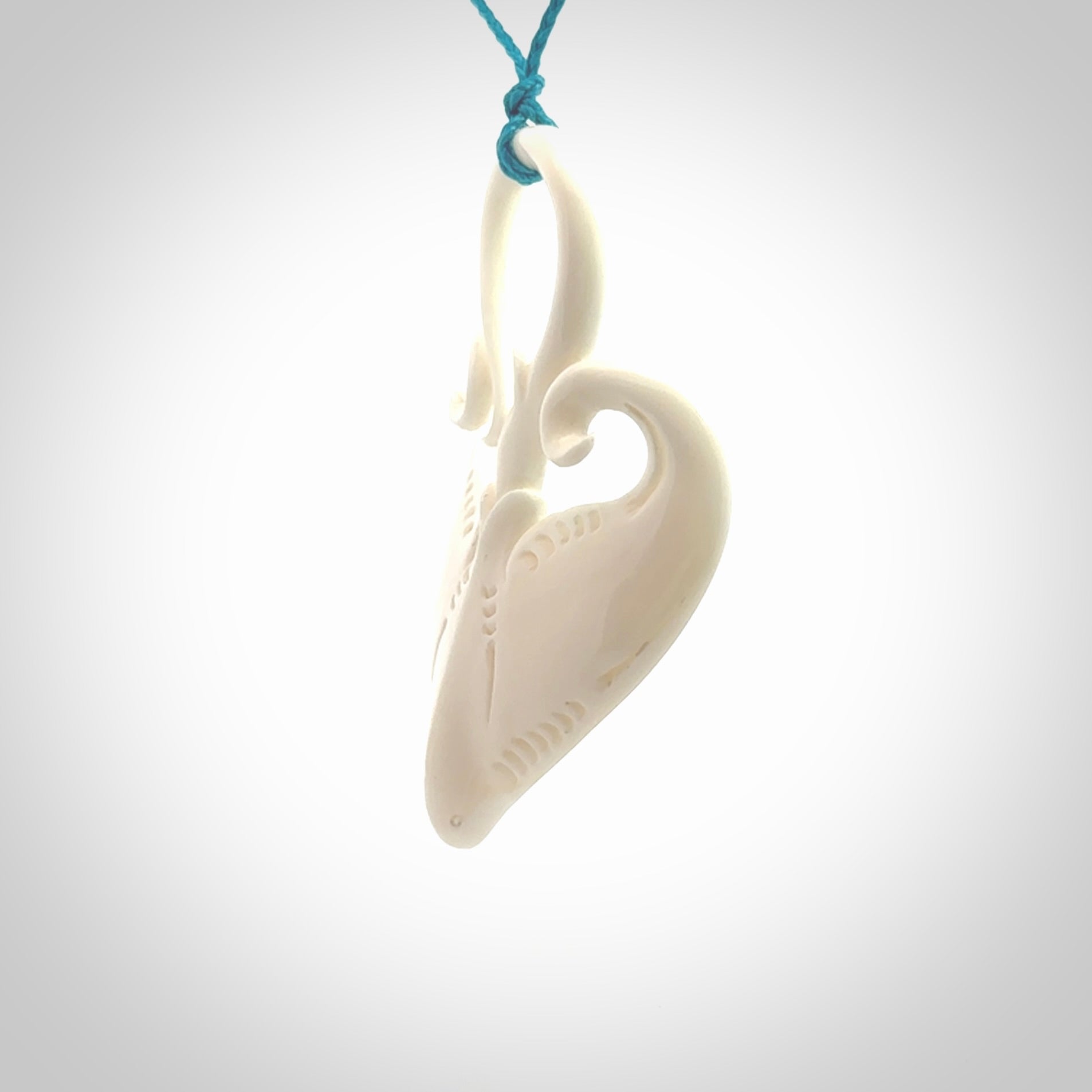 Hand carved large bone stingray pendant. Natural bone pendants from NZ Pacific. One only pendant provided with adjustable blue cord.