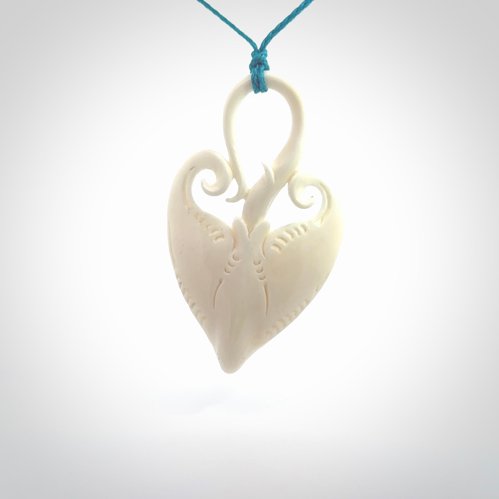 Hand carved large bone stingray pendant. Natural bone pendants from NZ Pacific. One only pendant provided with adjustable blue cord.