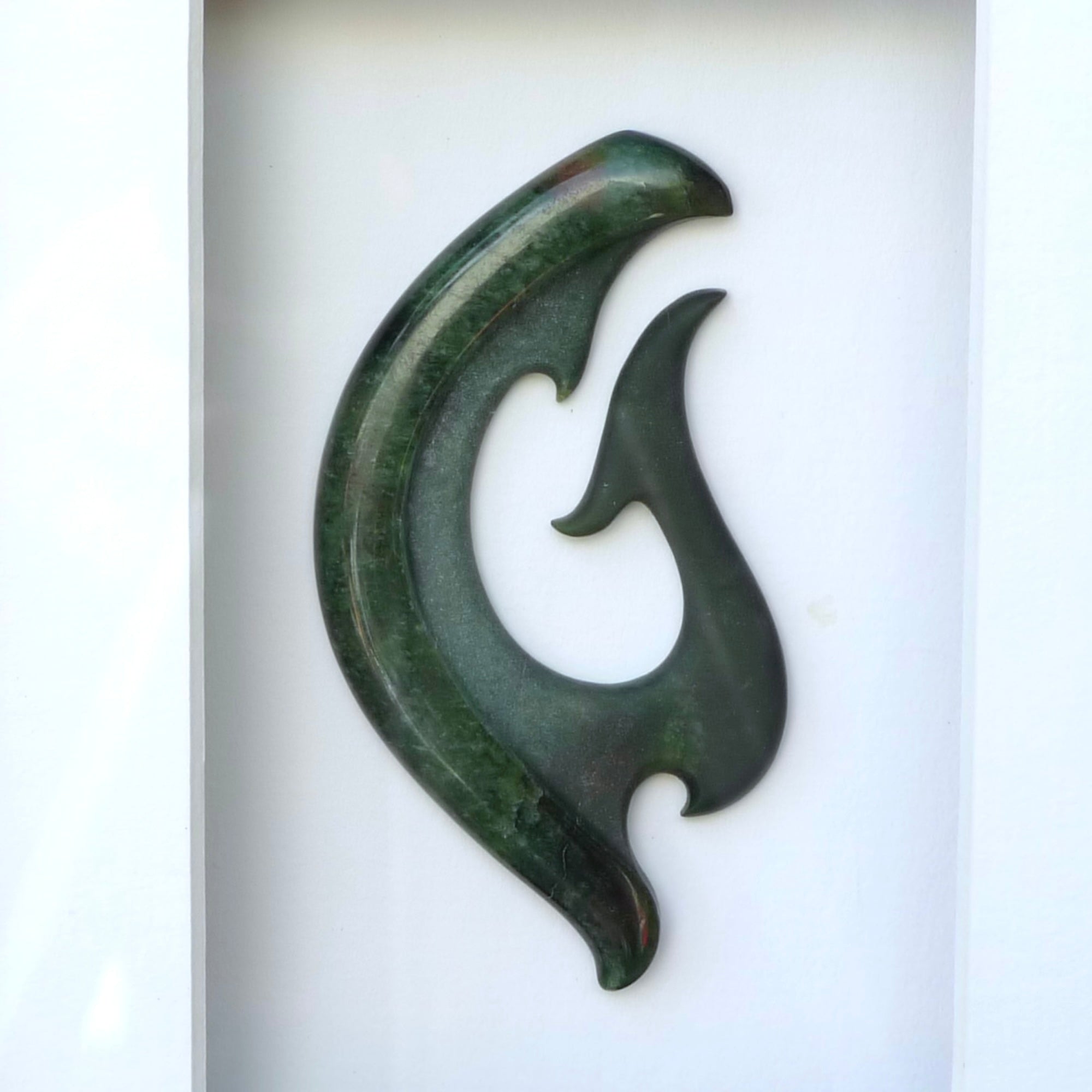 A hand carved large New Zealand Jade Koru necklace that has been framed and signed by artist Kerry Thompson. A large sized hand made koru necklace by New Zealand artist Kerry Thompson. One off framed work of art to wear. Delivered with Express Courier.