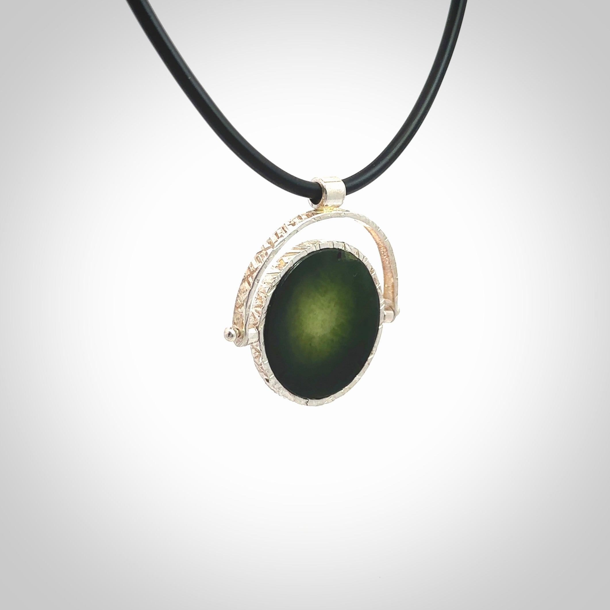 A photo of a New Zealand Jade drop pendant with sterling silver. This is a stylish statement piece - hand crafted here in New Zealand by Ana Krakosky. Unique Art to Wear. Gifts for all lovers of hand made Art to Wear. One only Fidget pendant.