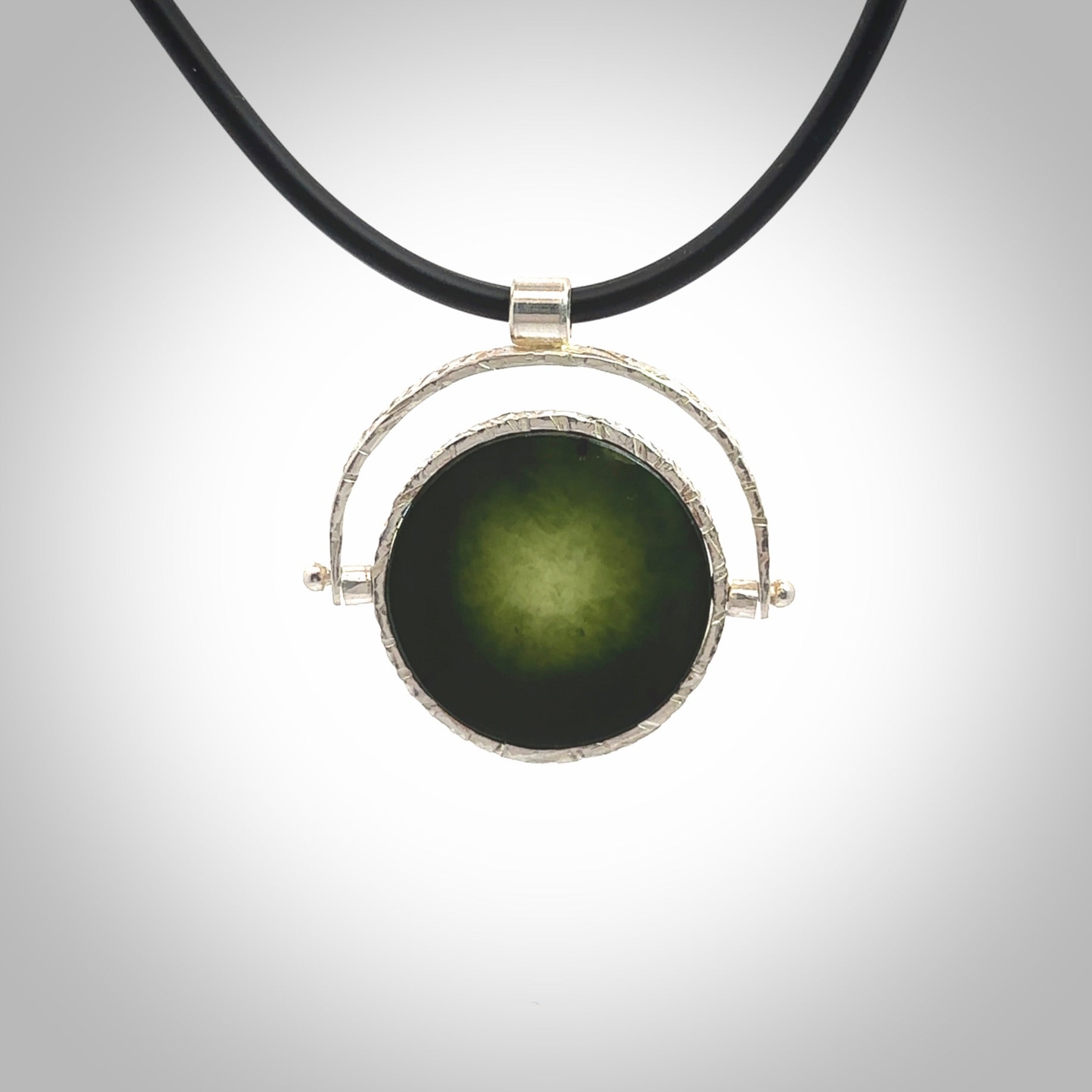 A photo of a New Zealand Jade drop pendant with sterling silver. This is a stylish statement piece - hand crafted here in New Zealand by Ana Krakosky. Unique Art to Wear. Gifts for all lovers of hand made Art to Wear. One only Fidget pendant.