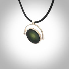 A photo of a New Zealand Jade drop pendant with sterling silver. This is a stylish statement piece - hand crafted here in New Zealand by Ana Krakosky. Unique Art to Wear. Gifts for all lovers of hand made Art to Wear. One only Fidget pendant.