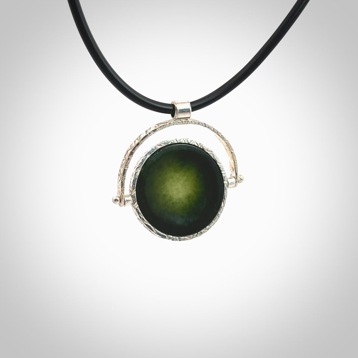 A photo of a New Zealand Jade drop pendant with sterling silver. This is a stylish statement piece - hand crafted here in New Zealand by Ana Krakosky. Unique Art to Wear. Gifts for all lovers of hand made Art to Wear. One only Fidget pendant.