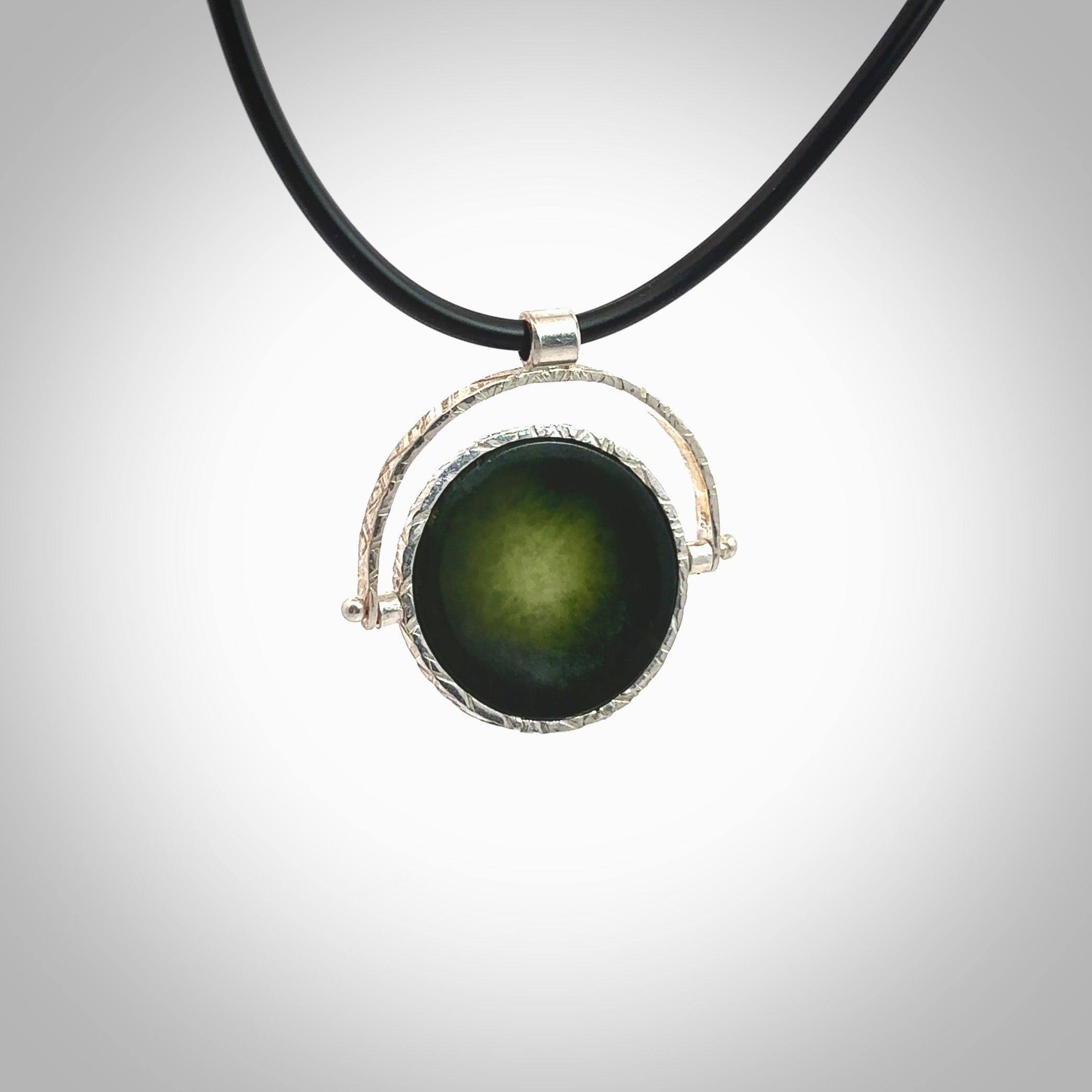 A photo of a New Zealand Jade drop pendant with sterling silver. This is a stylish statement piece - hand crafted here in New Zealand by Ana Krakosky. Unique Art to Wear. Gifts for all lovers of hand made Art to Wear. One only Fidget pendant.