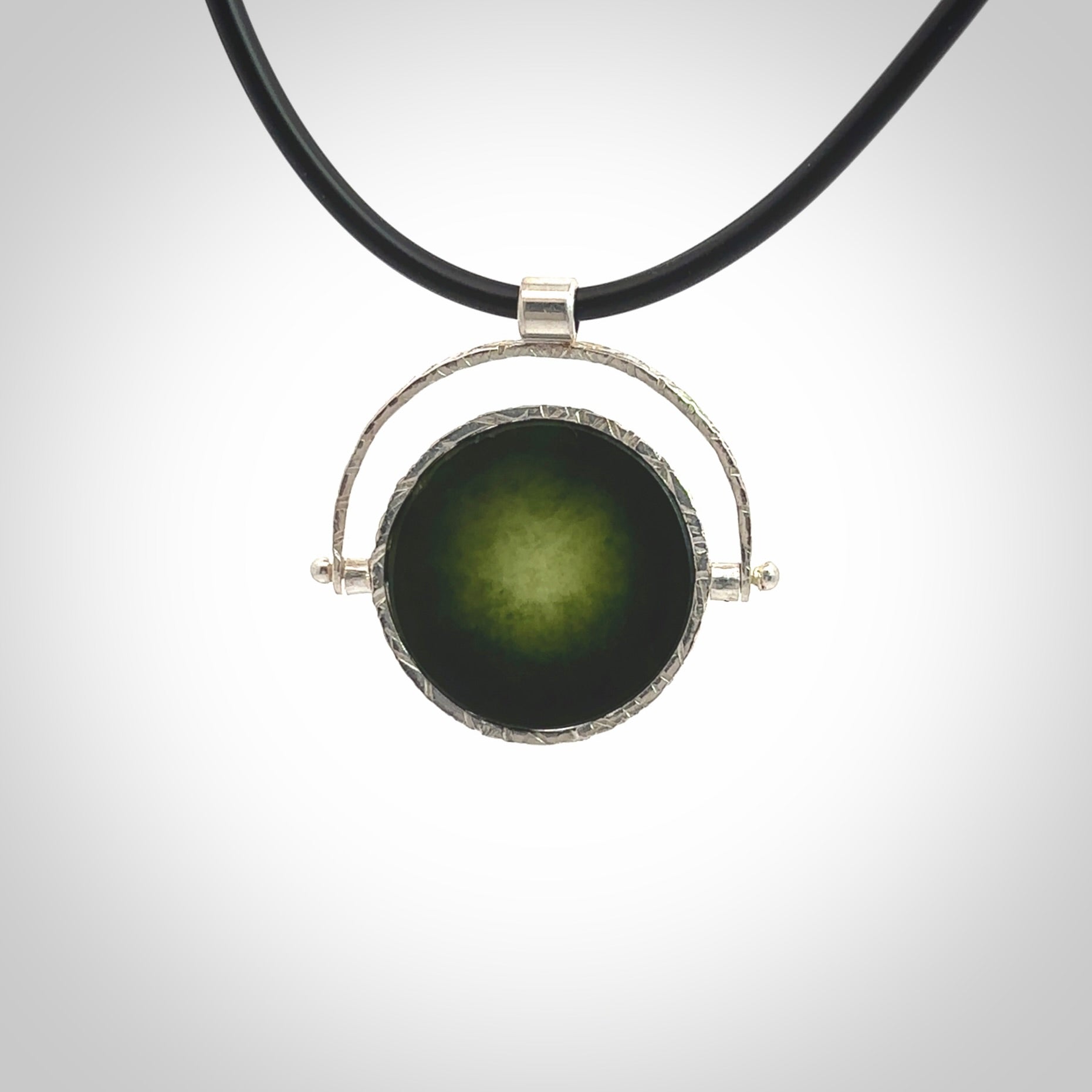 A photo of a New Zealand Jade drop pendant with sterling silver. This is a stylish statement piece - hand crafted here in New Zealand by Ana Krakosky. Unique Art to Wear. Gifts for all lovers of hand made Art to Wear. One only Fidget pendant.