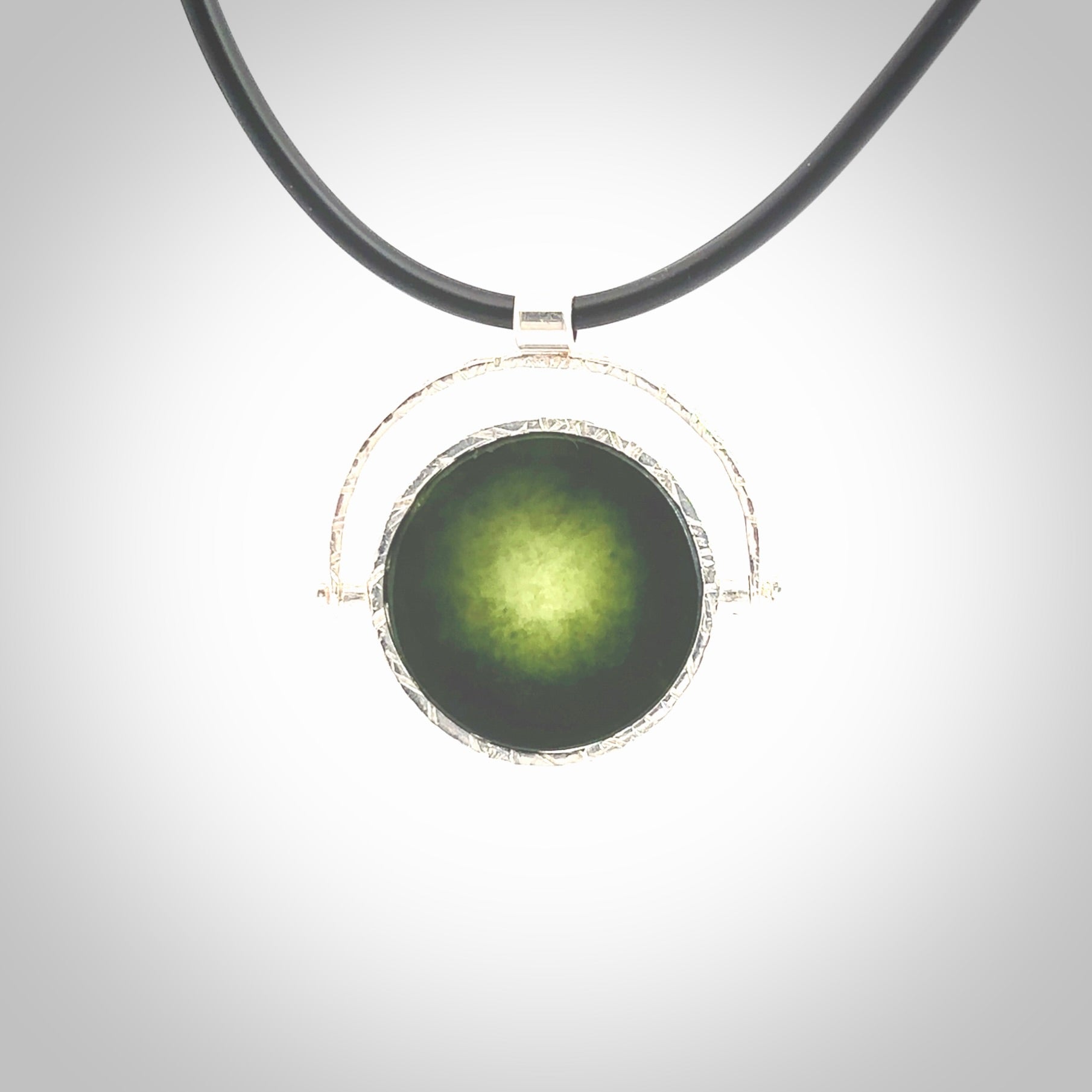 A photo of a New Zealand Jade drop pendant with sterling silver. This is a stylish statement piece - hand crafted here in New Zealand by Ana Krakosky. Unique Art to Wear. Gifts for all lovers of hand made Art to Wear. One only Fidget pendant.