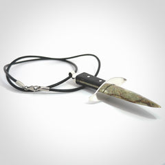 A striking hand carved knife pendant. These are carved with a green jade head and a hardwood handle. The necklace is made of leather and has a clasp fixture. We ship these worldwide with express courier.