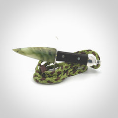 A striking hand carved knife pendant. These are carved with a green jade head and a hardwood handle. The cords are hand plaited in our waxed polyester which is robust, strong and durable. We ship these worldwide with express courier.