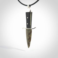 A striking hand carved knife pendant. These are carved with a green jade head and a hardwood handle. The necklace is made of leather and has a clasp fixture. We ship these worldwide with express courier.