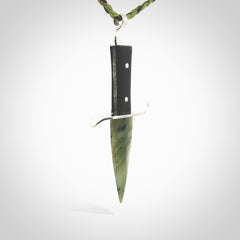 A striking hand carved knife pendant. These are carved with a green jade head and a hardwood handle. The cords are hand plaited in our waxed polyester which is robust, strong and durable. We ship these worldwide with express courier.