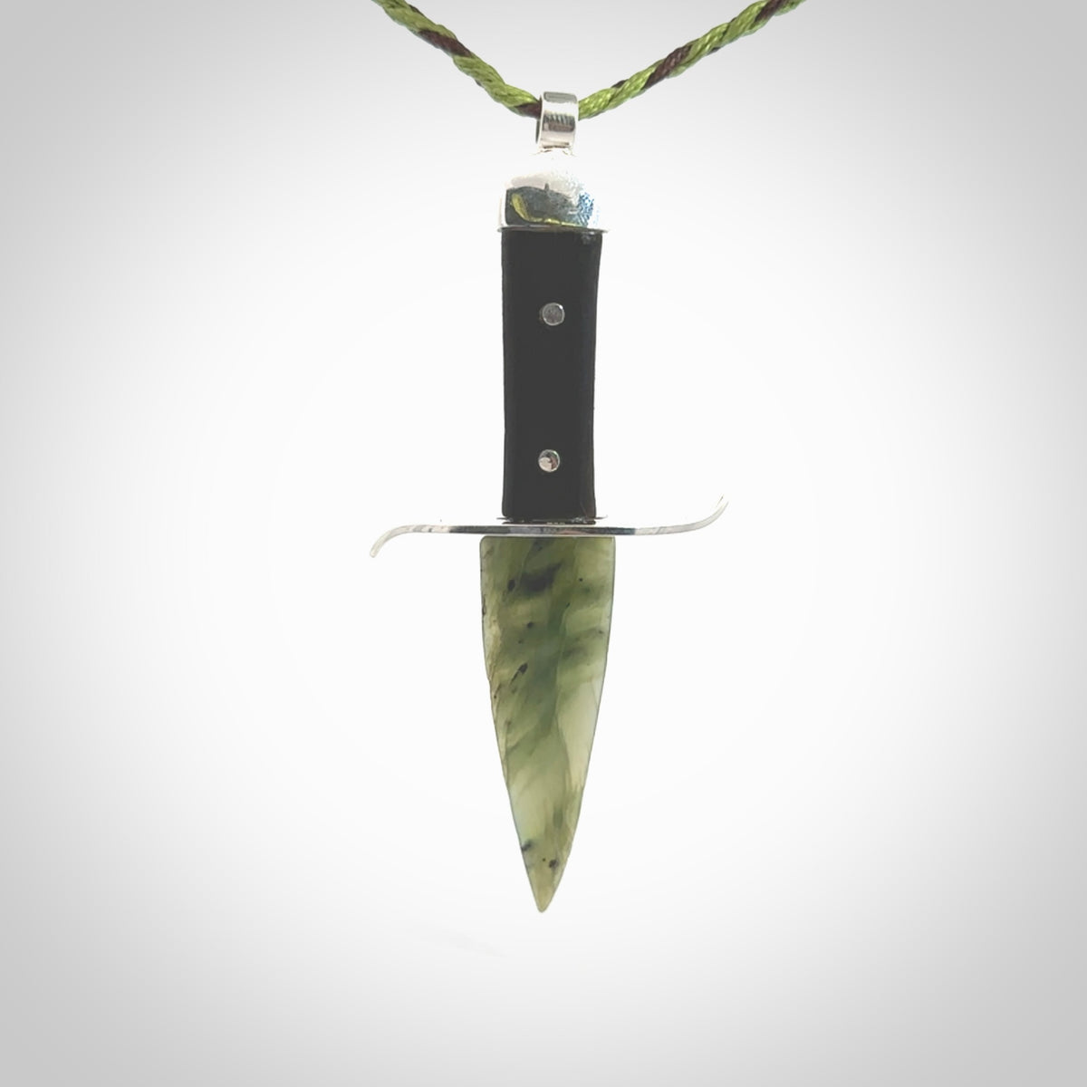 A striking hand carved knife pendant. These are carved with a green jade head and a hardwood handle. The cords are hand plaited in our waxed polyester which is robust, strong and durable. We ship these worldwide with express courier.