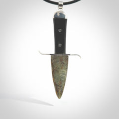 A striking hand carved knife pendant. These are carved with a green jade head and a hardwood handle. The necklace is made of leather and has a clasp fixture. We ship these worldwide with express courier.