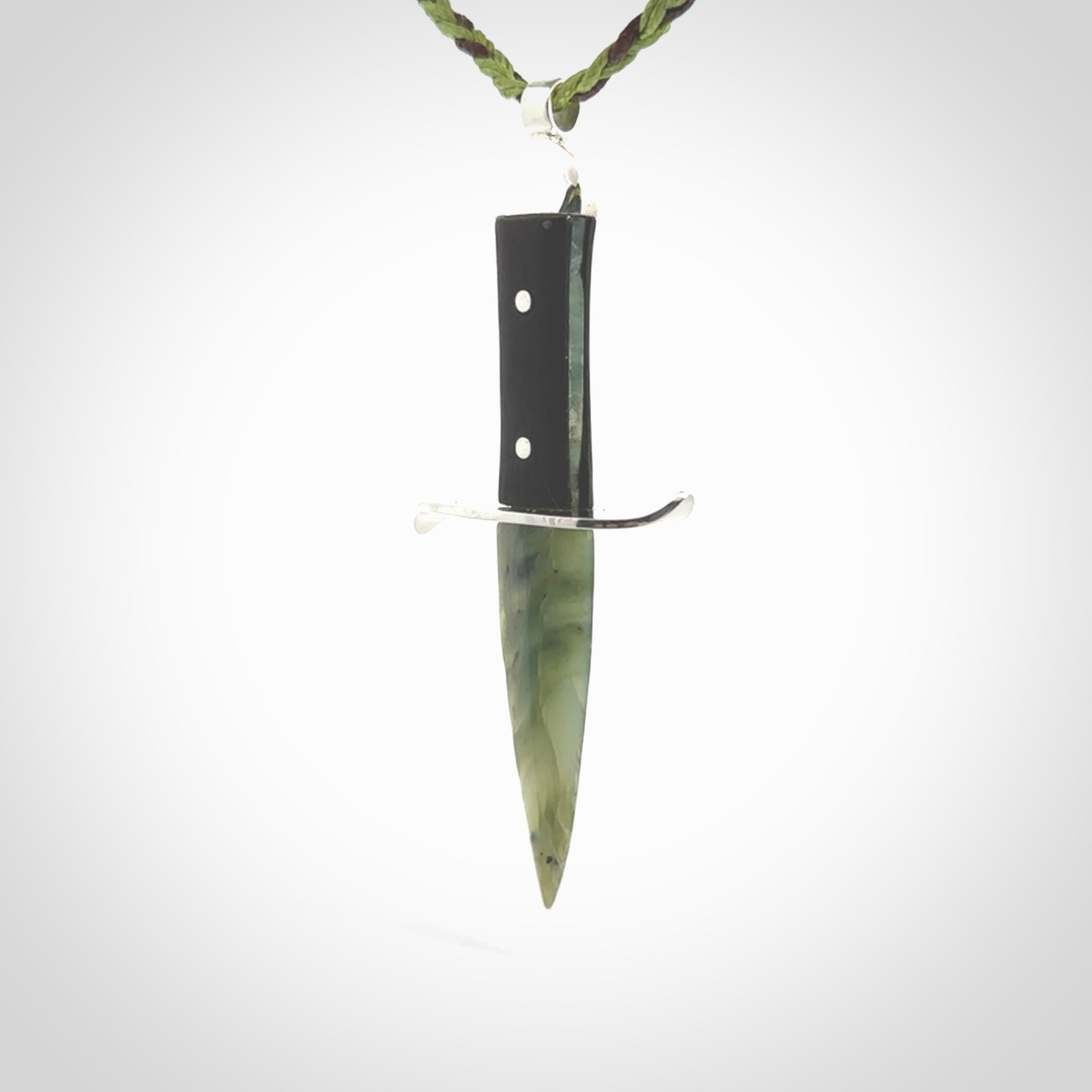 A striking hand carved knife pendant. These are carved with a green jade head and a hardwood handle. The cords are hand plaited in our waxed polyester which is robust, strong and durable. We ship these worldwide with express courier.