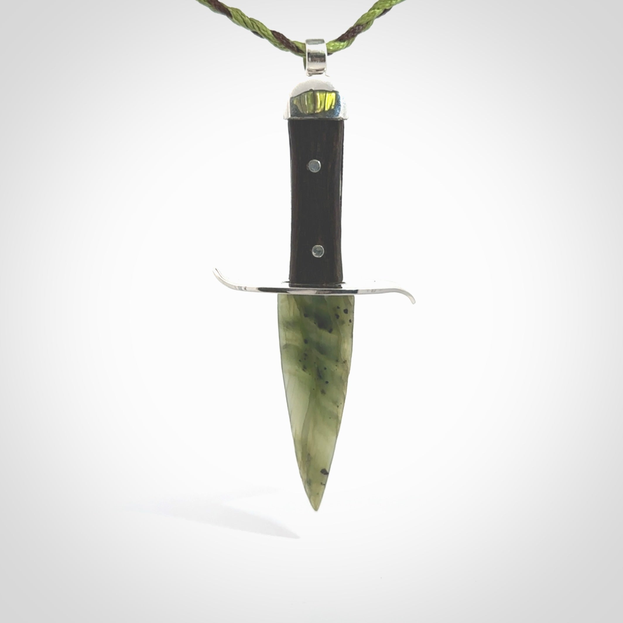 A striking hand carved knife pendant. These are carved with a green jade head and a hardwood handle. The cords are hand plaited in our waxed polyester which is robust, strong and durable. We ship these worldwide with express courier.