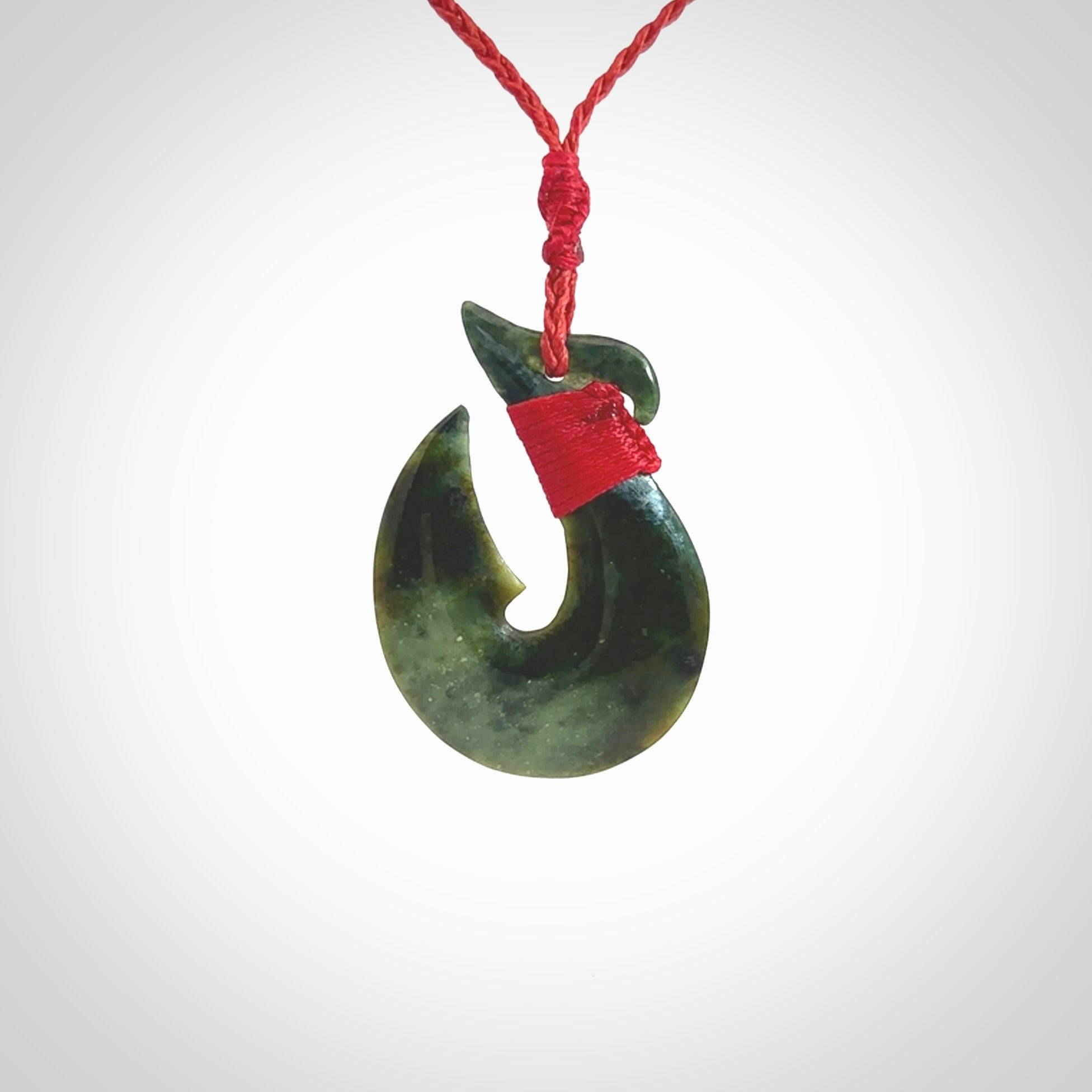 Hand carved New Zealand Jade Hook Pendant. Maori matau necklace hand carved. Jade Hook pendant provided with adjustable cord and packaged in a woven kete pouch. Delivered with Express Courier.