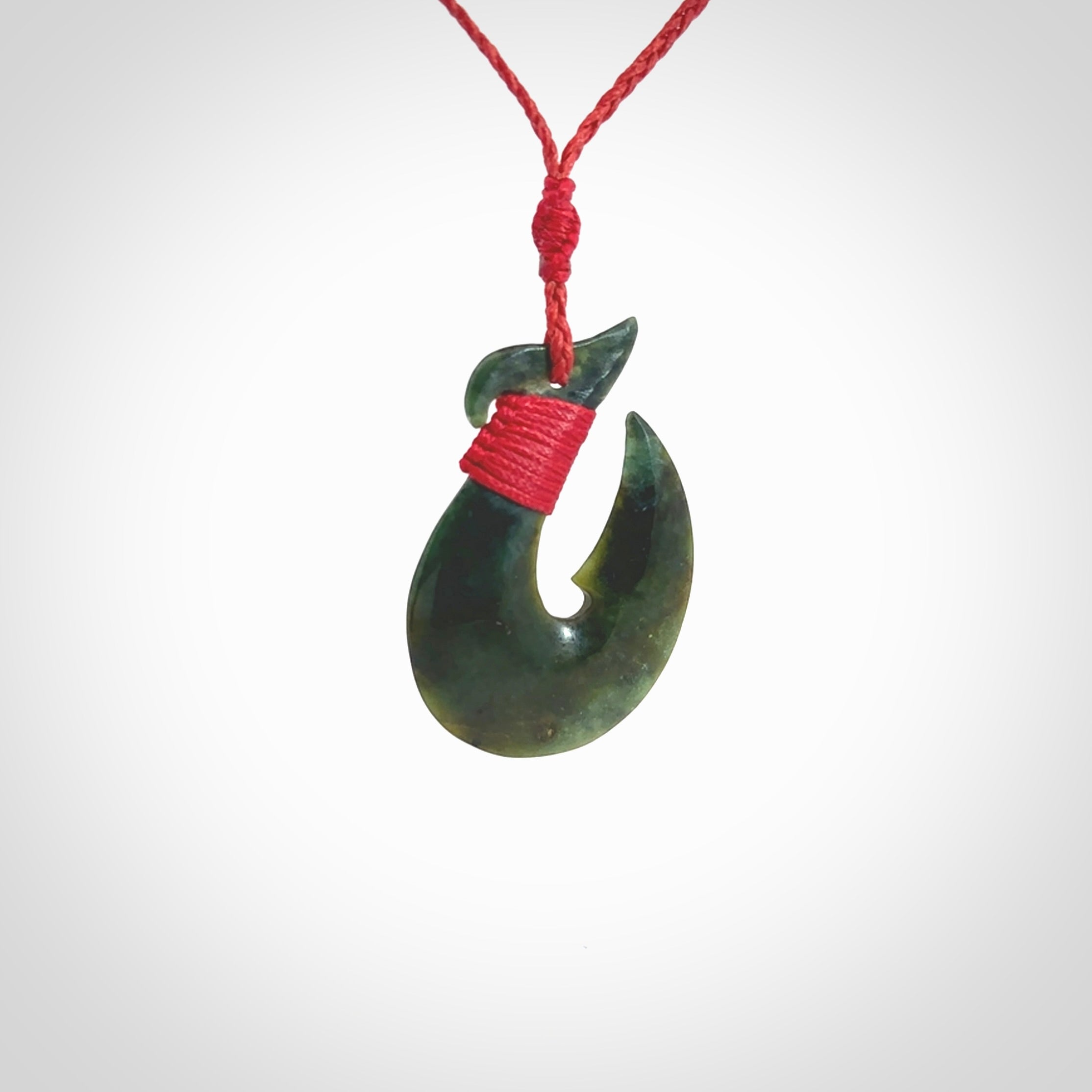 Hand carved New Zealand Jade Hook Pendant. Maori matau necklace hand carved. Jade Hook pendant provided with adjustable cord and packaged in a woven kete pouch. Delivered with Express Courier.