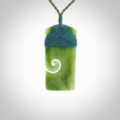 New Zealand jade toki koru pendant. Hand carved in New Zealand. Hand made New Zealand Jade jewellery. Provided with an adjustable cord and packaged in a woven kete pouch.