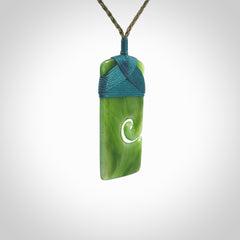 New Zealand jade toki koru pendant. Hand carved in New Zealand. Hand made New Zealand Jade jewellery. Provided with an adjustable cord and packaged in a woven kete pouch.