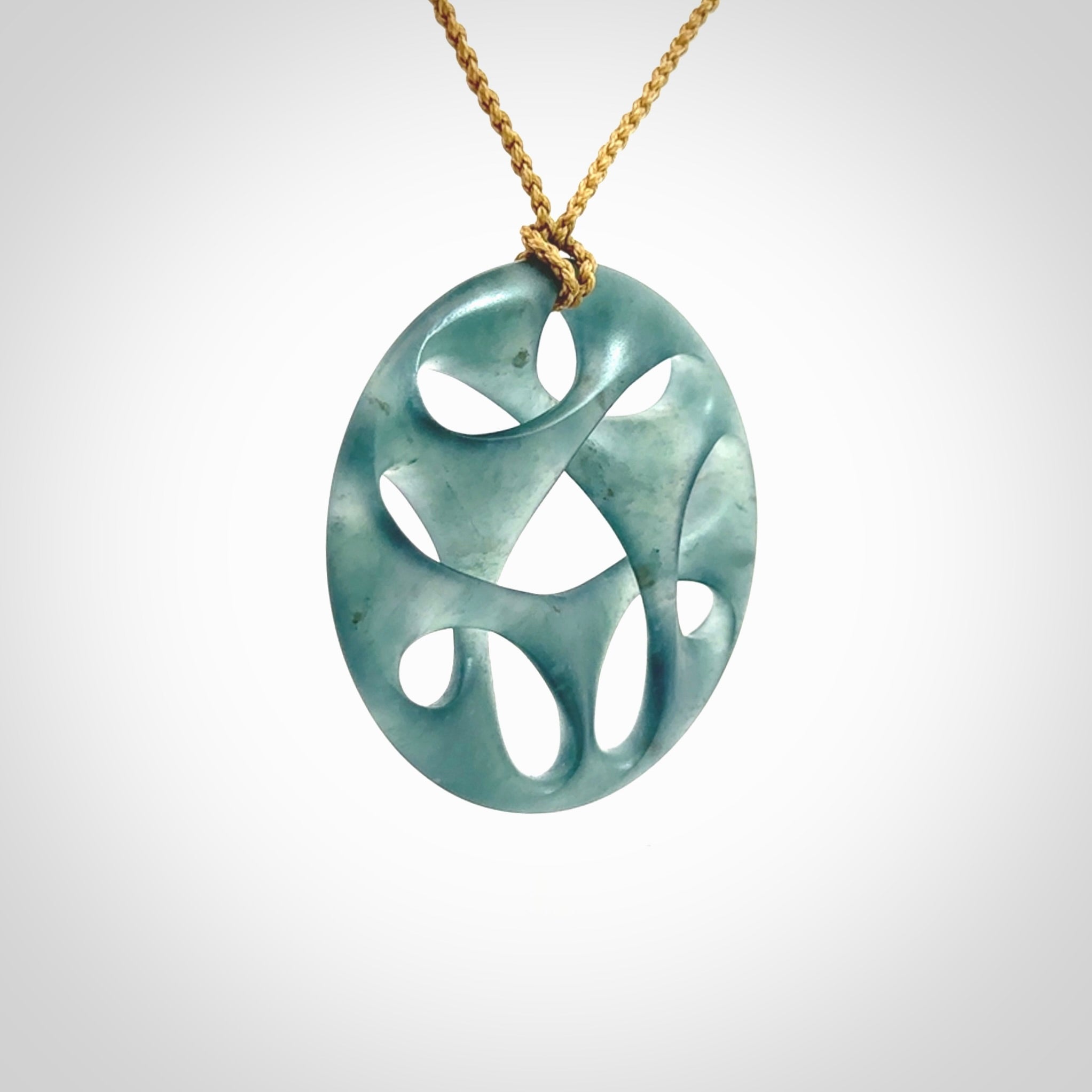 This large piece is a hand carved complex twist pendant. Kerry carved this from Guatemalan Jade. It is a gorgeous blue colour and is an artistic piece of jewellery. Hand made by Kerry Thompson and delivered to you in a kete pouch.